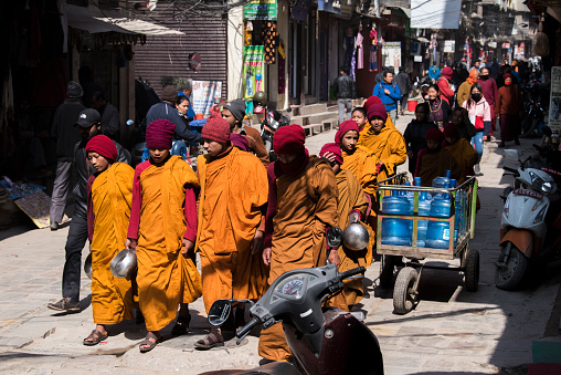 Kathmandu, Nepal- April 20,2023 : Buddhist monks walk the streets of Kathmandu, the capital of Nepal.