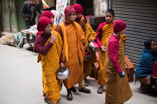 Kathmandu, Nepal- April 20,2023 : Buddhist monks walk the streets of Kathmandu, the capital of Nepal.