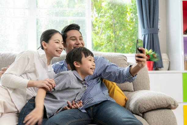istock happy family take a selfie at home 1992664318