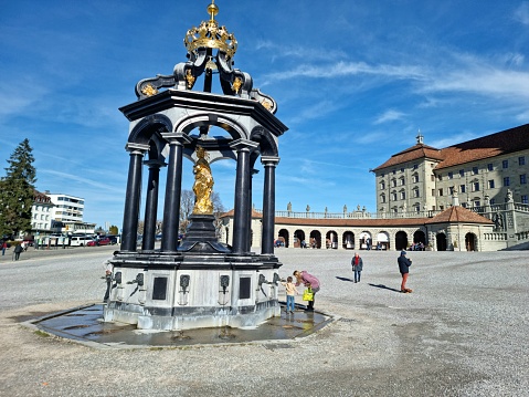 The Abbey of Einsiedeln is one of the most important baroque monastic sites and the largest place of pilgrimage in Switzerland. The image shows the building exterior with a  drinking fountain.