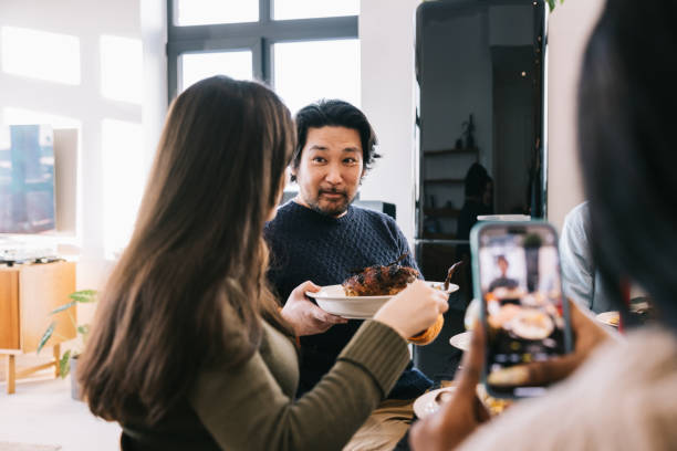istock Diverse friends sharing christmas roast during holiday feast 1992693464