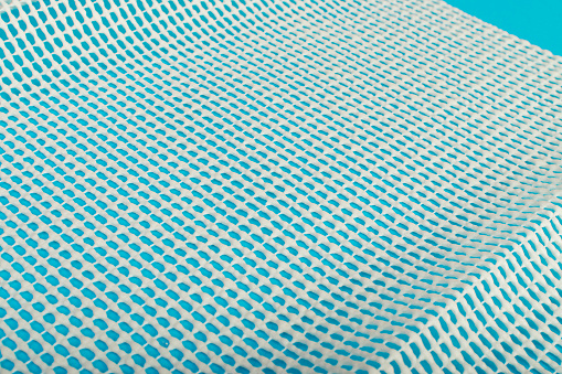 Anti-Slip Underlay to Prevent Rugs from Moving, Rubber Mesh for Placing Under Carpet on Blue Background