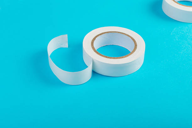 istock White Electrical Tape, Plastic Duct Tape Rolls, Colored Adhesive Tapes on Blue Background 1992696766