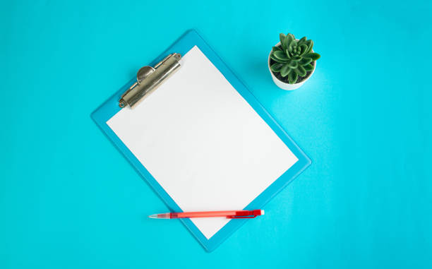istock Blank Paper Tablet Top View, Empty White Sheet on Blue Table Flat Lay Mockup, Paper Tablet Texture Background 1992697308