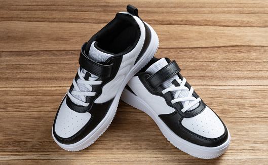 pair of black and white sporty shoes for kid