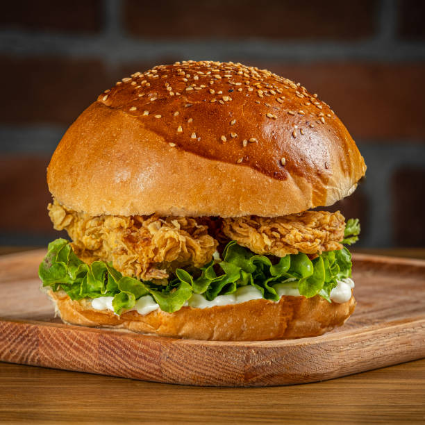 istock Crispy chicken burger on a wooden floor 1992699907