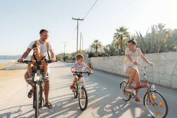 istock Young family riding bicycles in summertime 1992701999
