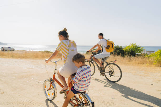 istock Young family riding bicycles in summertime 1992706721