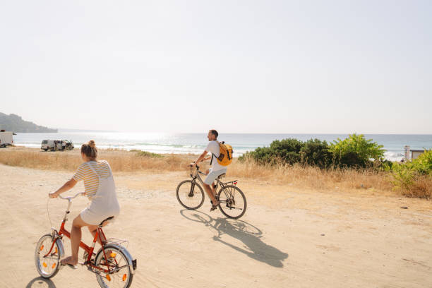 istock Loving couple exploring coastline on a bicycles 1992707778