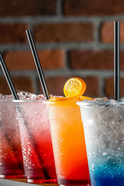 istock Colored mojito drink with different flavors on a red brick background 1992709894