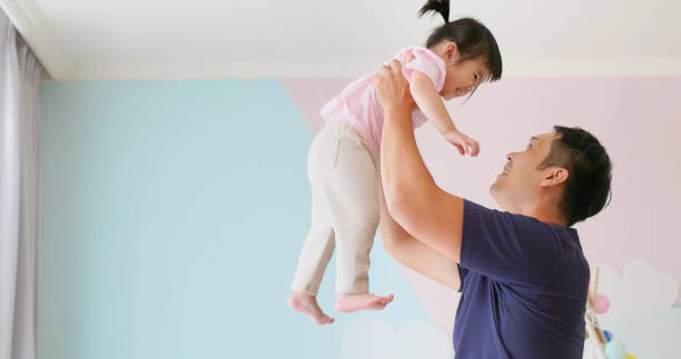 istock Asian father hold high kid 1992710456