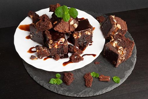 Nut Brownie, Homemade German Chocolate Cake, Chocolate Peanuts Cake, Brownie Square Piece on Black Stone Background