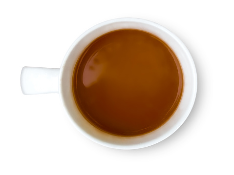 Top view of coffee with milk in a white mug isolated on a white background.