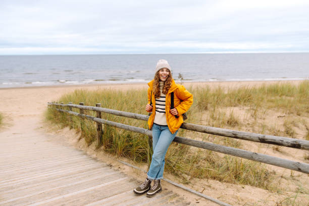 istock Happy tourist   posing by the sea. 1992716964