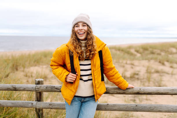 istock Happy tourist   posing by the sea. 1992716974