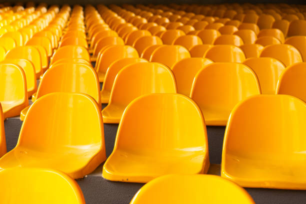 Top view of yellow seats on sport stadium with the chairs are lined up