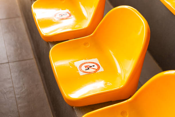 Plenty of yellow plastic seats at stadium. Bright yellow seats for fans at a football stadium in summer