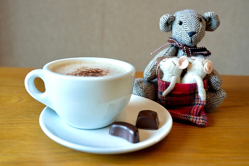 Coffee latte cappuccino cup and saucer with chocolates and Cuddly teddy bear and two cute sleeping mice