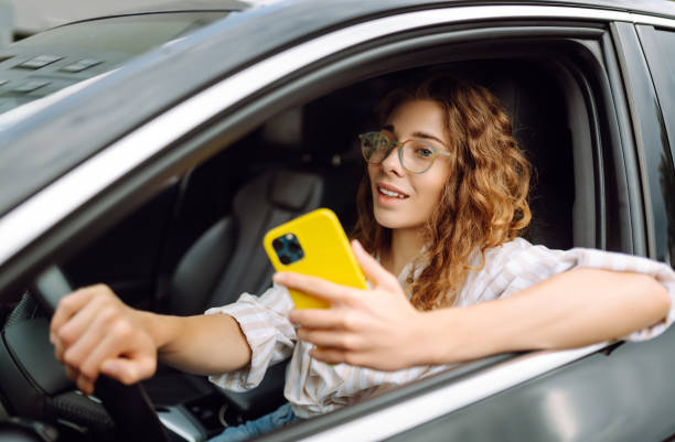 istock A woman driver  with phone. 1992737182