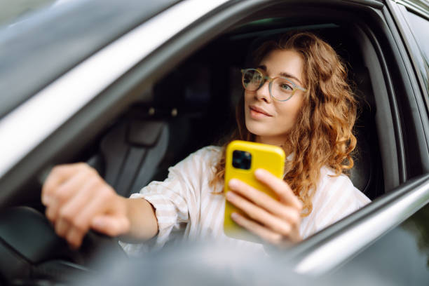 istock A woman driver  with phone. 1992737700