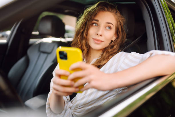 istock A woman driver  with phone. 1992737710