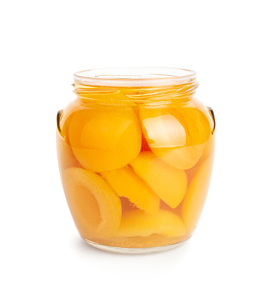 Canned Peaches in Glass Jar Isolated, Apricot Halves in Syrup, Yellow Fruit Dessert, Tinned Nectarine Compote, Orange Peeled Peache Slices on White Background