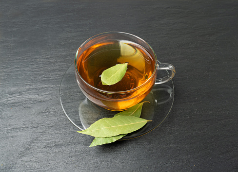 Aromatic herbal tea with thyme on wooden table, space for text