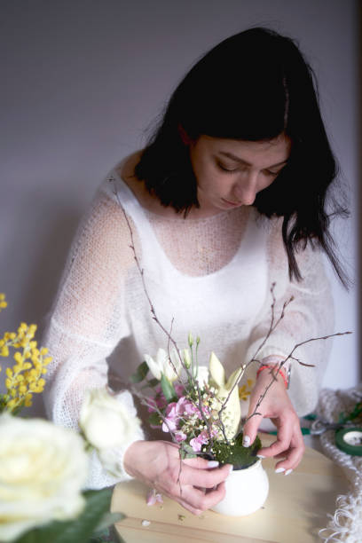 istock female florist make decorations and floral arrangements for Easter 1992754901