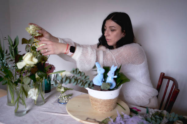 female florist make decorations and floral arrangements for Easter