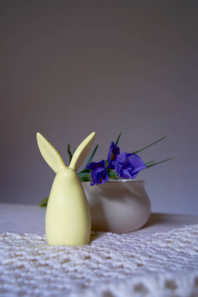 istock minimalist irises on white ceramic vase on table with easter bunny 1992755488