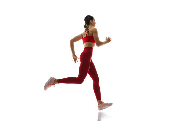 istock Dynamics, endurance and energy. Female runner athlete in motion, running, training against white studio background 1992797146
