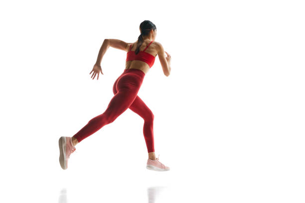 istock Muscular young woman, runner athlete in motion, training against white studio background. Competitive spirit 1992797151