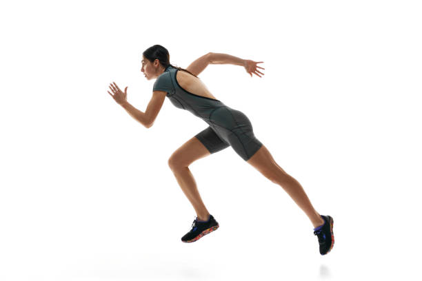 istock Athletic young woman, female runner, athlete in motion, training, running against white studio background 1992797155