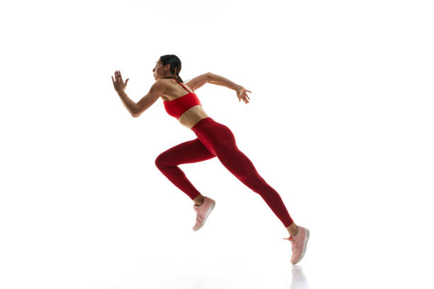 istock Competitive, concentrated young woman, runner athlete training, running against white studio background 1992797688