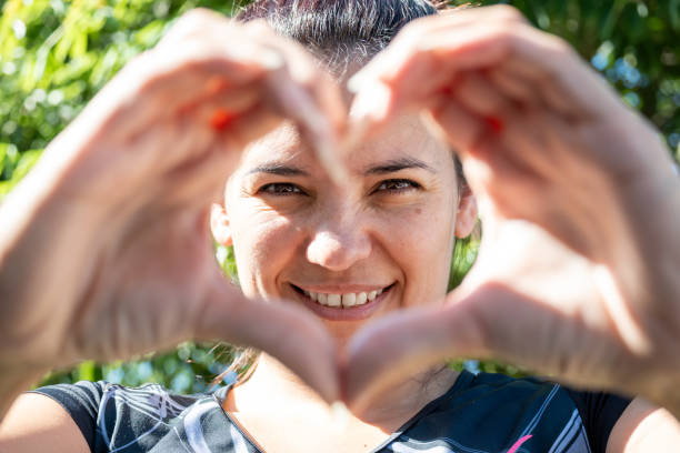 istock Latin woman making a heart with her hands 1992807832