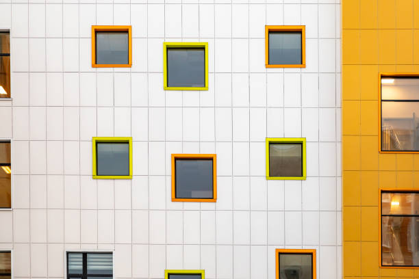 istock Multicoloured square windows on white wall of commercial building. Ventilated facade. Part of an urban property 1992808374