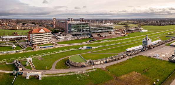 York Racecourse, York, UK - February 5, 2024. Aerial panorama landscape above York Racecourse horse racing track with the home straight and winning post overlooked by the stadium Grandstand