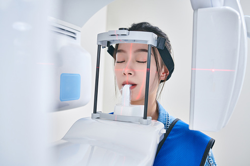 Side view of one asian young women dental 3D panoramic scanning.