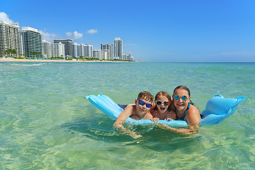 Family joy in a holiday paradise - Miami Beach. Happy moments in the clean  water.