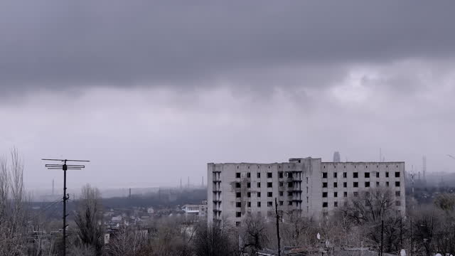 Moving Gray Cumulus Clouds Against the Background of Empty Abandoned Building