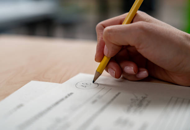istock Close-up on a teacher grading an educational exam 1992829688