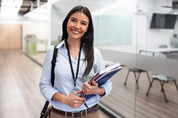 istock Teacher working at the university and looking at the camera smiling 1992829732