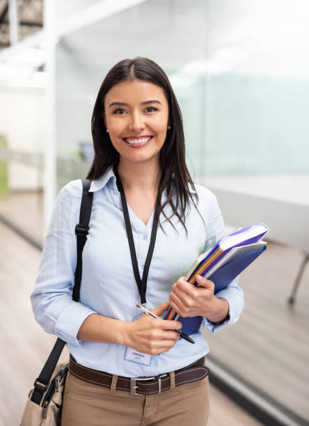 Professor working at the university and looking at the camera smiling