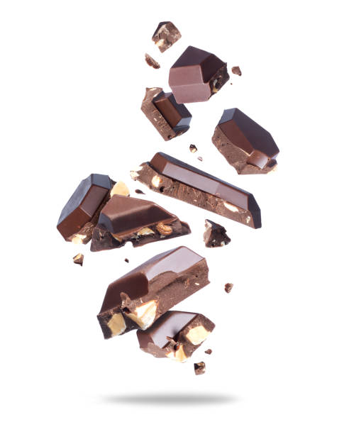 istock Broken chocolate bar with nuts in the air close up on a white background 1992844714