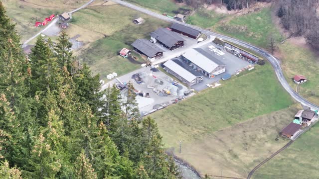 Rescue helicopter fly toward helipad landing area, Switzerland mountain valley