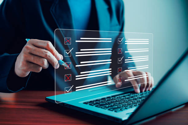 istock Audit, Assessment form, Businessman working on computer productivity checklist and filling survey form online. Digital and technology, website, testimonial, review, questionnaire, checklist, customer. 1992886165