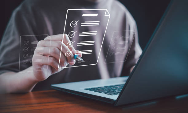 istock E-document management. Paperless workplace, Document management man signs an electronic document on a digital document by a virtual notebook screen. E-signing, Electronic signature, App, Contract. 1992892541