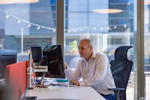 istock Businessman working on computer in office for digital app. 1992905834