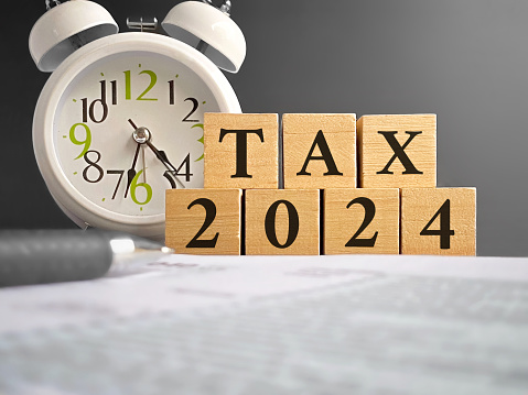 Tax 2023 word on wooden blocks background. Tax filing concept.
