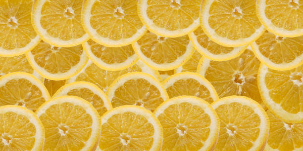 istock Lemon slices background. Slices of lemon mixed theme. 1992919525